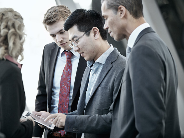 businesspeople looking at tablet