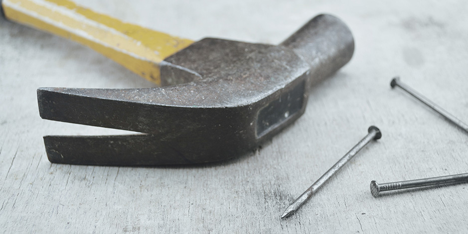 hammer and nails on wood board